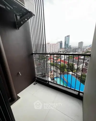 Modern balcony with city view in high-rise apartment, perfect for urban living.