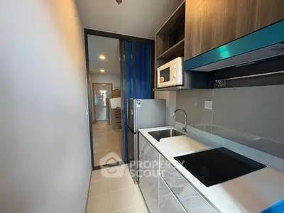 Modern compact kitchen with sleek appliances and stylish cabinetry