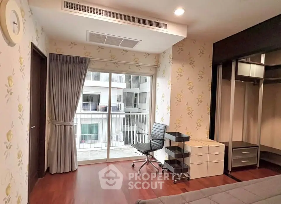 Spacious bedroom with modern furniture and balcony view in a stylish apartment.