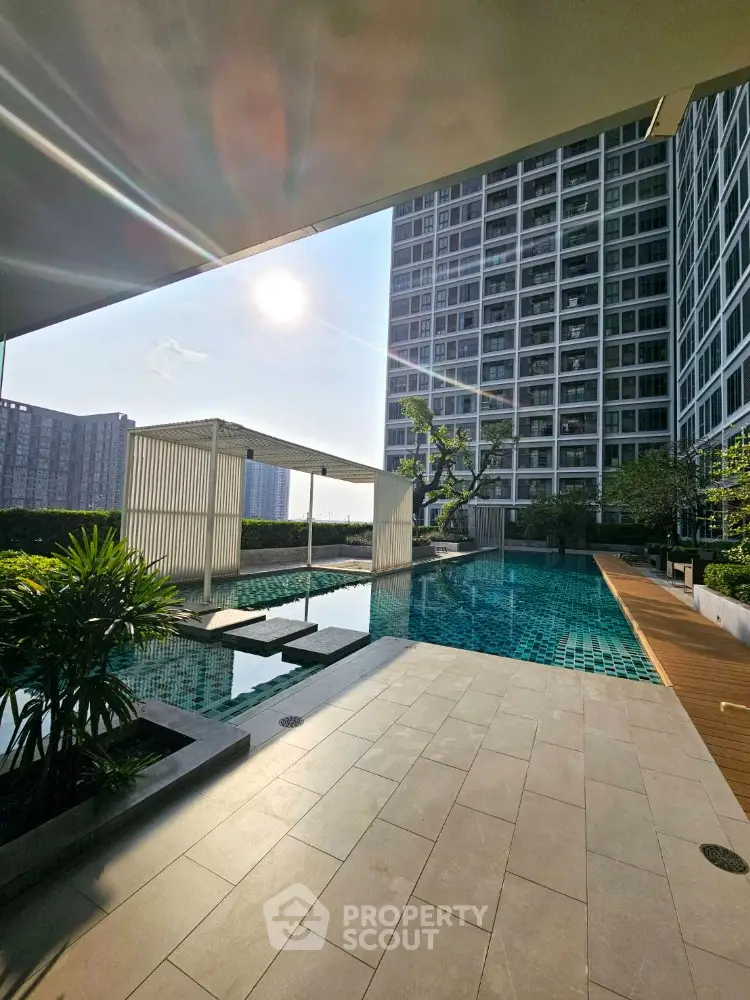 Luxurious rooftop pool with stunning cityscape view in modern high-rise building.
