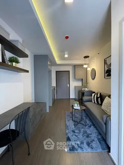 Modern living room with stylish decor and open layout, featuring cozy seating and elegant lighting.