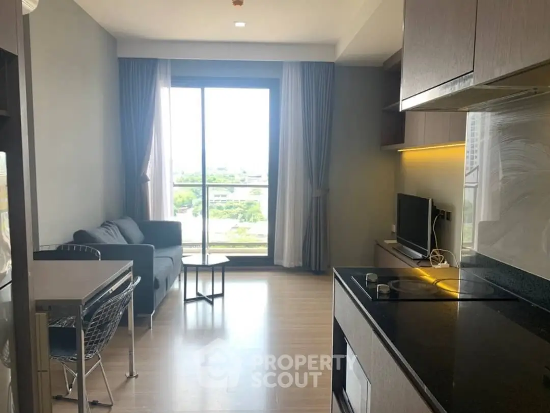 Modern living room with large window and stylish furniture in a cozy apartment.