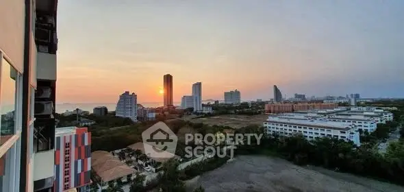 Stunning cityscape view at sunset with high-rise buildings and lush greenery.