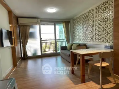 Modern living room with stylish decor and balcony view in a cozy apartment.