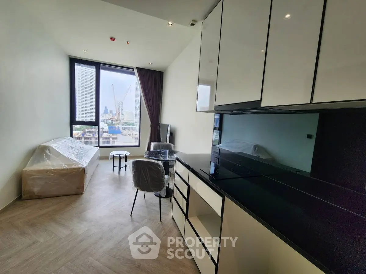 Modern apartment with city view, sleek kitchen, and cozy living area