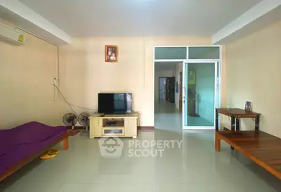 Spacious living room with modern furniture and sleek flooring, perfect for relaxation and entertainment.