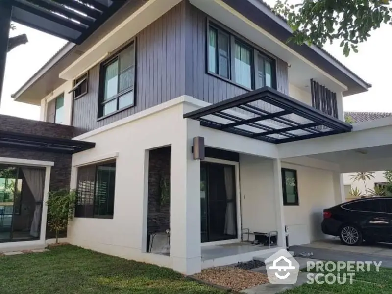 Modern two-story house with carport and landscaped garden