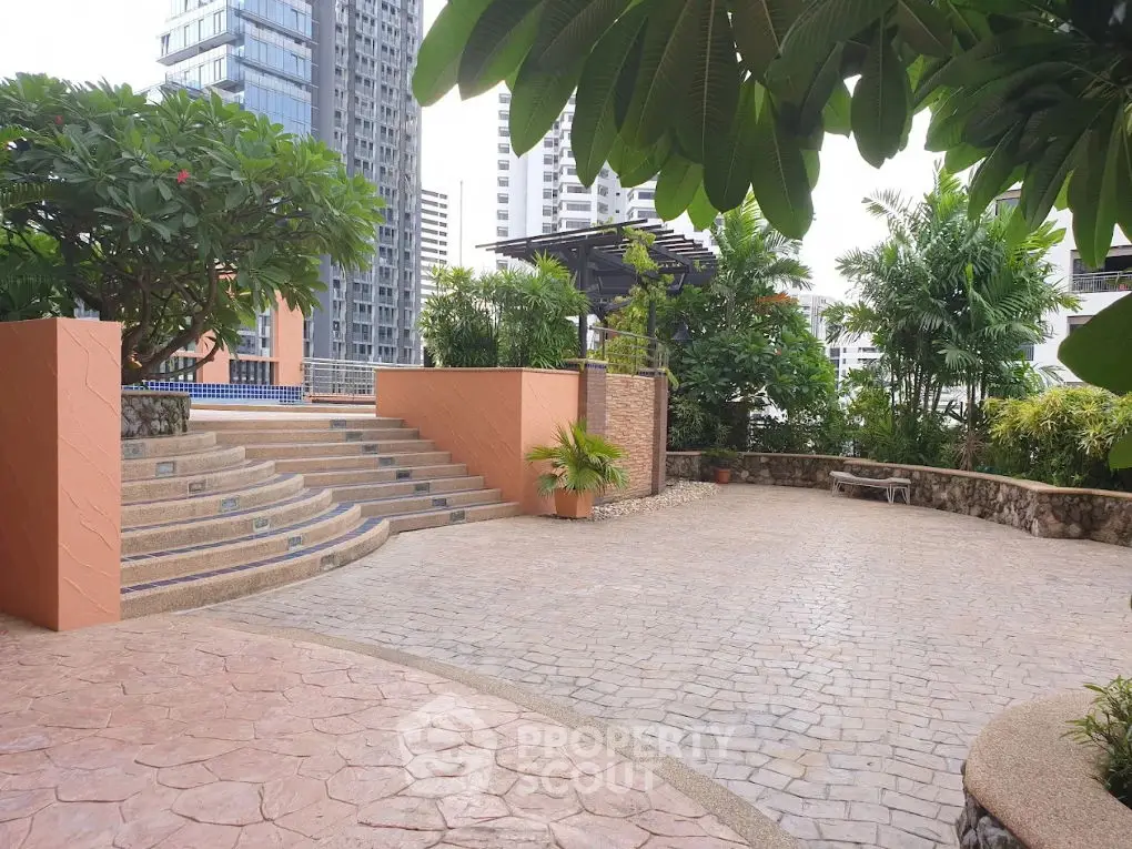 Spacious outdoor garden area with lush greenery and modern architecture