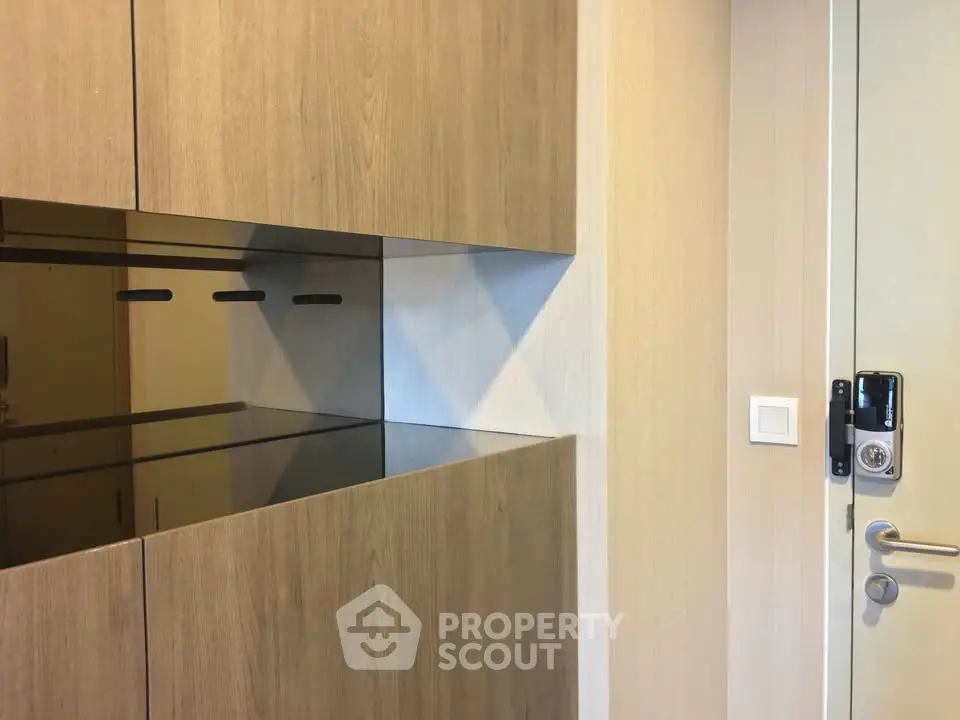 Modern kitchen with sleek wooden cabinets and electronic door lock