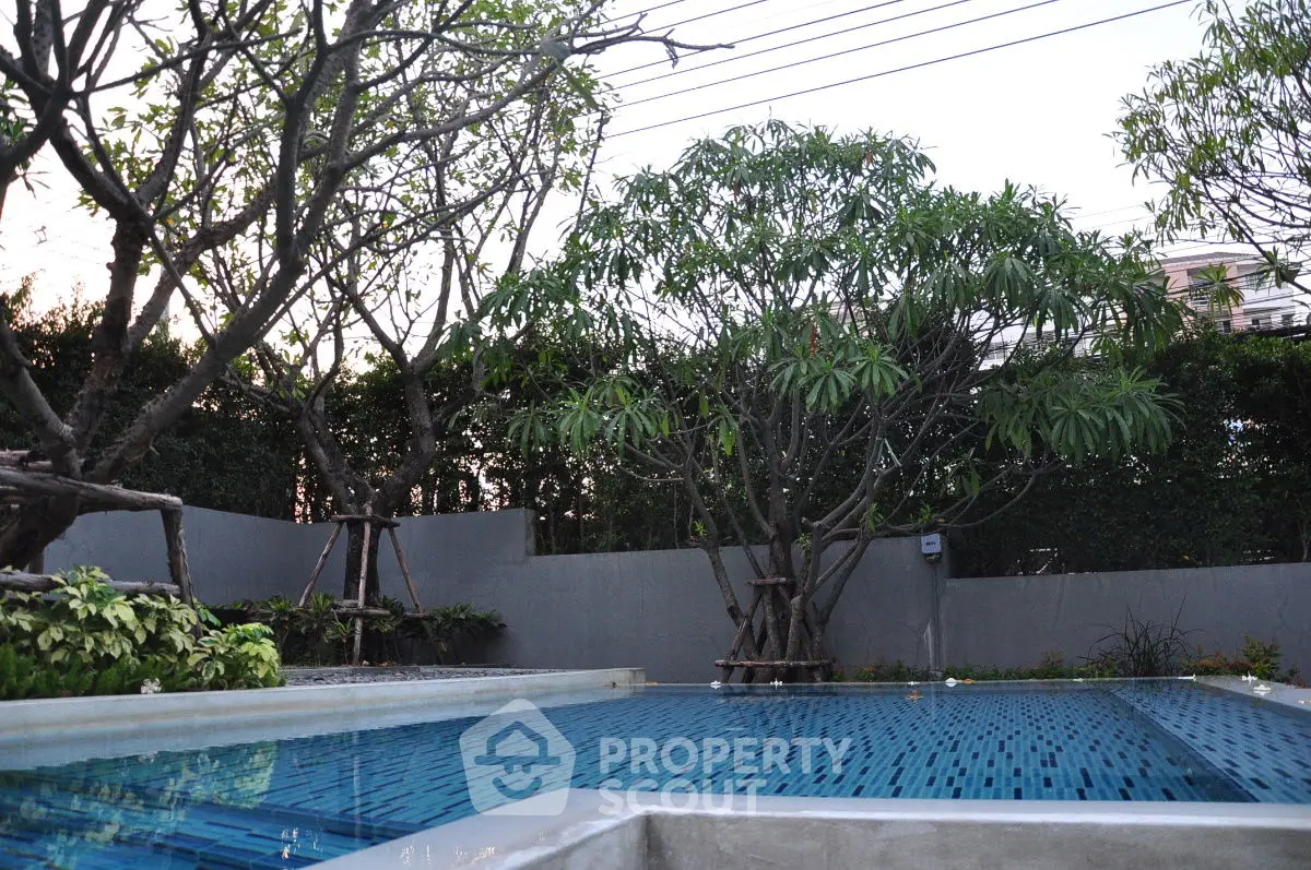 Luxurious private pool surrounded by lush greenery and modern design