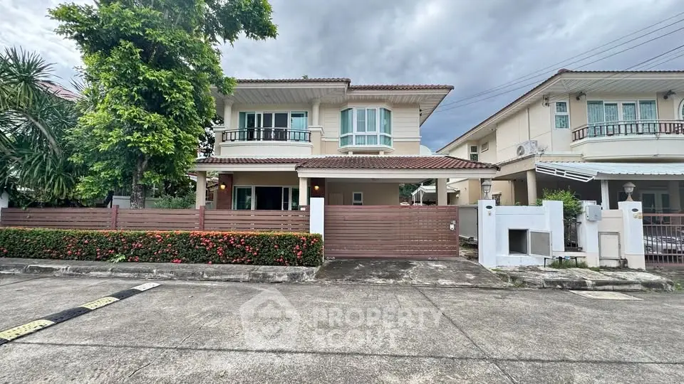 Charming two-story house with lush greenery and modern design in a serene neighborhood.