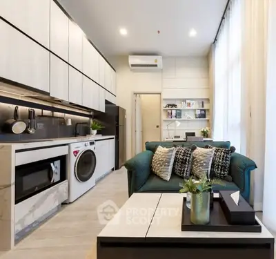 Modern living room with integrated kitchen and stylish decor in a contemporary apartment.