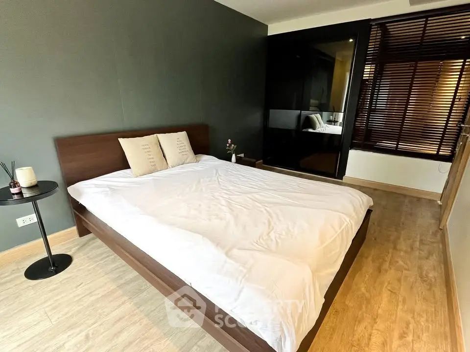 Modern bedroom with sleek wooden flooring and stylish decor