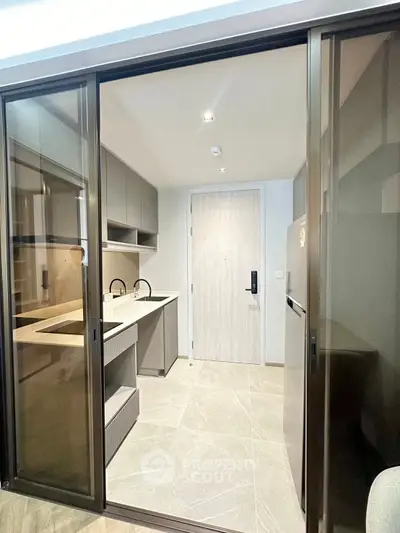 Modern kitchen with sleek cabinetry and sliding glass doors