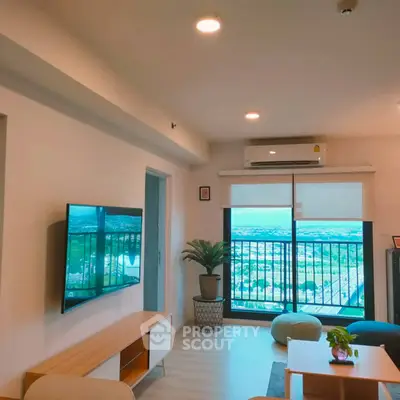 Modern living room with balcony view and stylish decor in high-rise apartment.