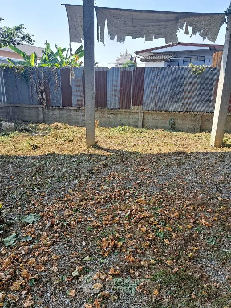 Vacant land with potential for development, featuring a rustic fence and natural surroundings.