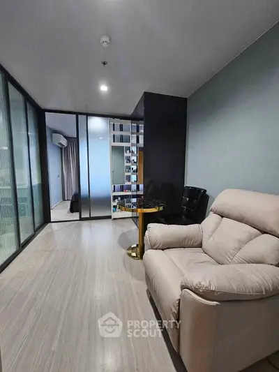 Modern living room with sleek design and comfortable seating in a stylish apartment.
