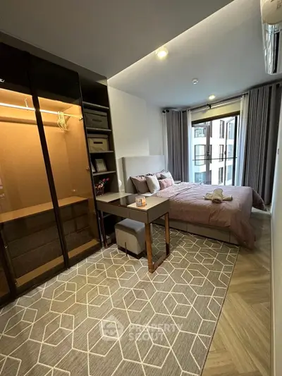 Modern bedroom with stylish decor and large window offering natural light