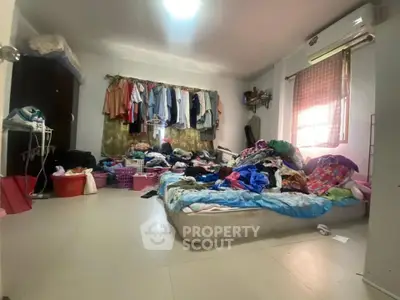 Spacious bedroom with natural light, air conditioning, and ample storage potential, ideal for creative organization.