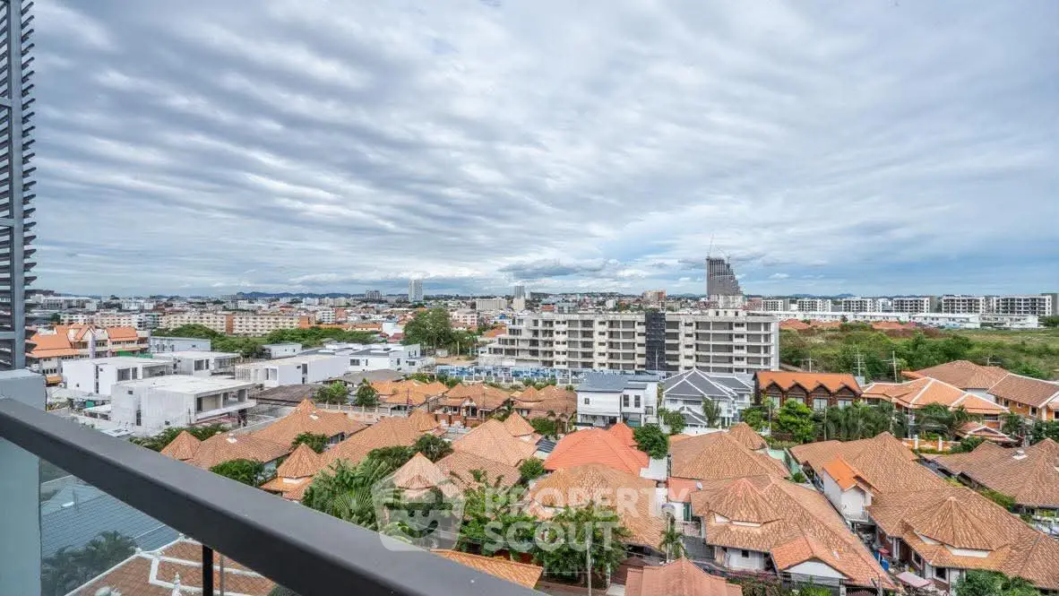 Stunning panoramic view from balcony overlooking vibrant cityscape and rooftops.