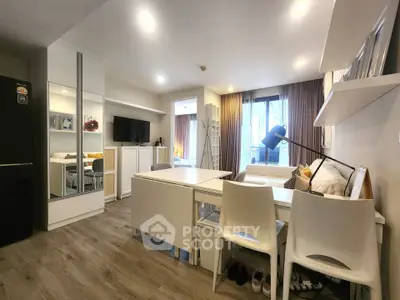 Modern studio apartment with sleek furnishings and ample natural light, featuring a cozy living area and stylish decor.