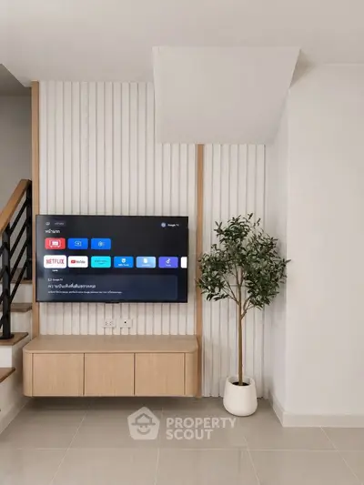 Modern living room with wall-mounted TV and stylish decor