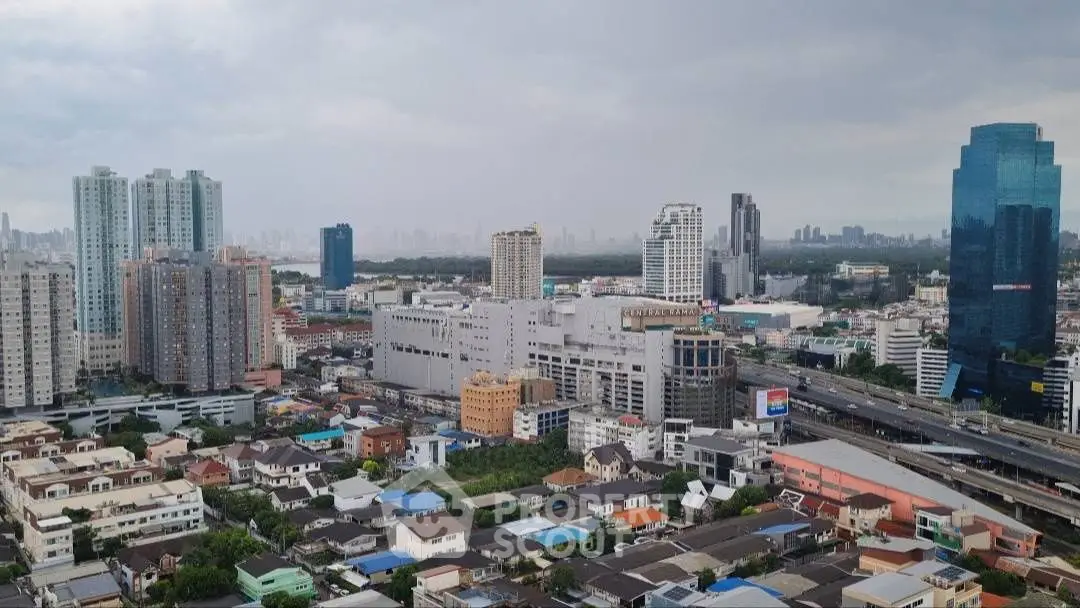 Aerial view of urban skyline with high-rise buildings and residential area.
