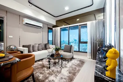 Luxurious modern living room with city view, plush furniture, and elegant decor.
