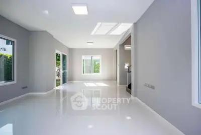 Spacious and bright living room with large windows and modern design.