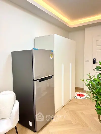 Modern kitchen with sleek fridge and stylish cabinetry in a bright interior.