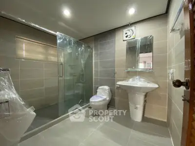 Modern bathroom with glass shower enclosure and sleek fixtures