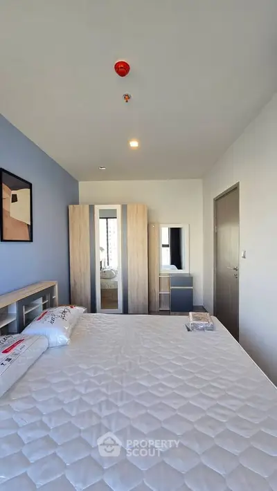 Modern bedroom with stylish decor and ample natural light