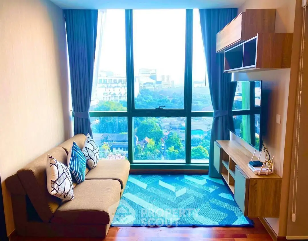 Modern living room with large window offering stunning city view, stylish furniture, and vibrant decor.