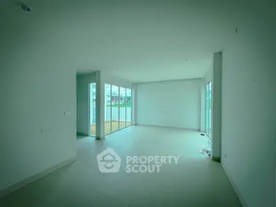 Spacious empty living room with large windows and natural light