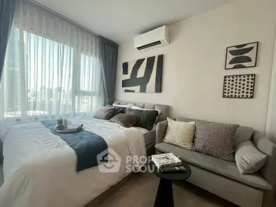 Modern bedroom with stylish decor and city view, featuring a cozy bed and elegant sofa.