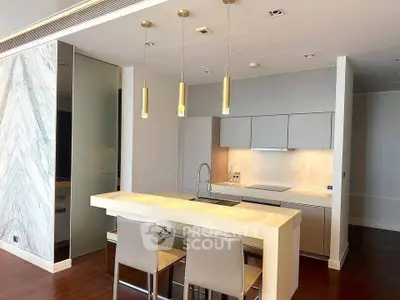 Modern kitchen with sleek design, featuring a breakfast bar and pendant lighting, perfect for contemporary living.