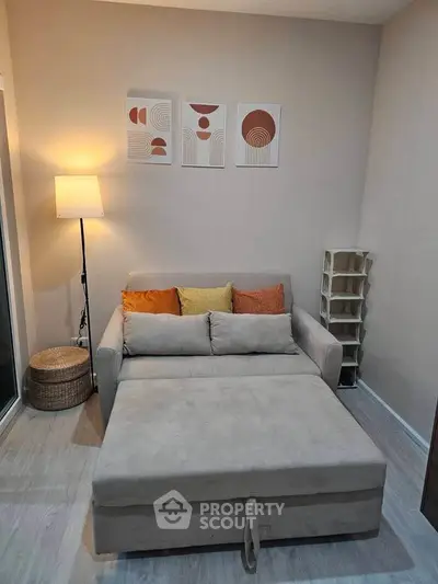 Cozy living room with modern decor and comfortable sofa bed, perfect for relaxation and stylish living.