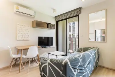 Modern living room with stylish decor and balcony access in a contemporary apartment.
