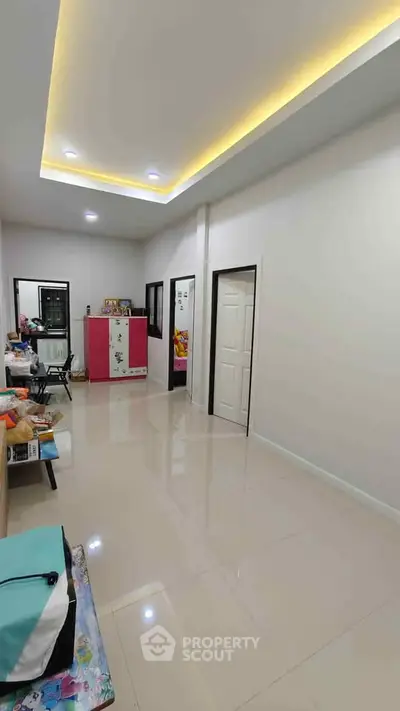 Spacious modern living room with glossy tiled floors and recessed lighting