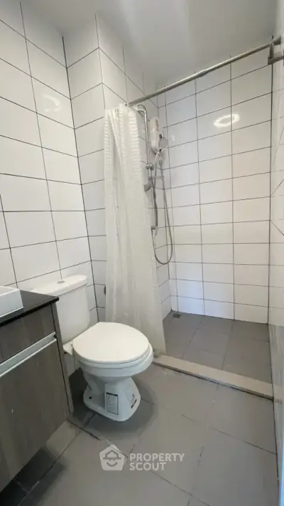 Modern bathroom with sleek tiles and walk-in shower
