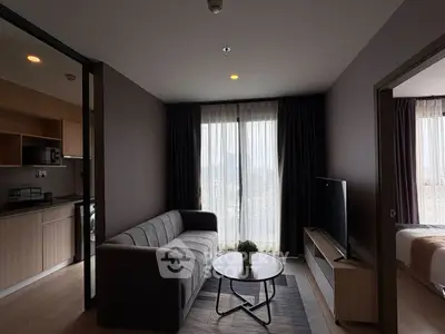 Modern living room with sleek furniture and open kitchen layout