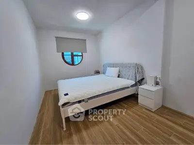 Cozy minimalist bedroom with modern design and wooden flooring