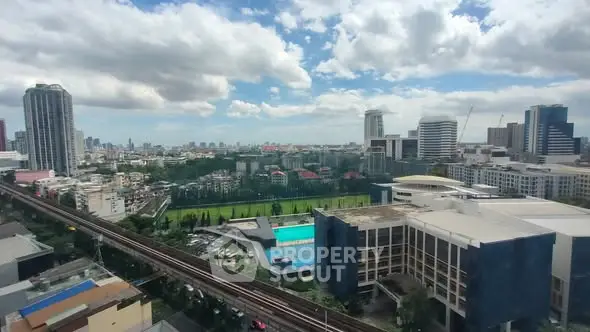 Stunning cityscape view with modern buildings and lush greenery under a vibrant sky.