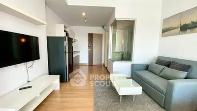 Modern living room with sleek furniture and open kitchen layout