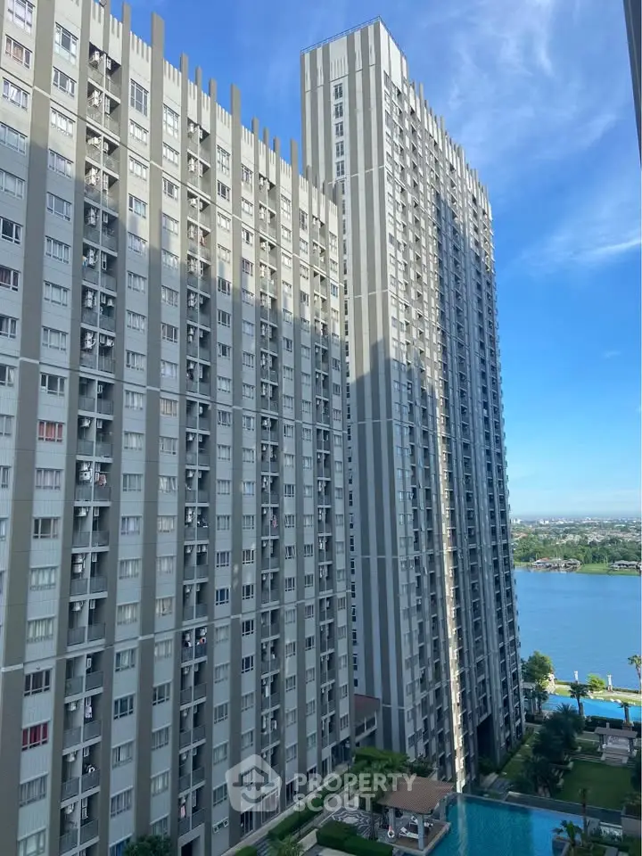 Stunning high-rise building with pool and river view, perfect for urban living.