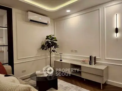 Elegant living room with modern decor, featuring air conditioning and stylish lighting.