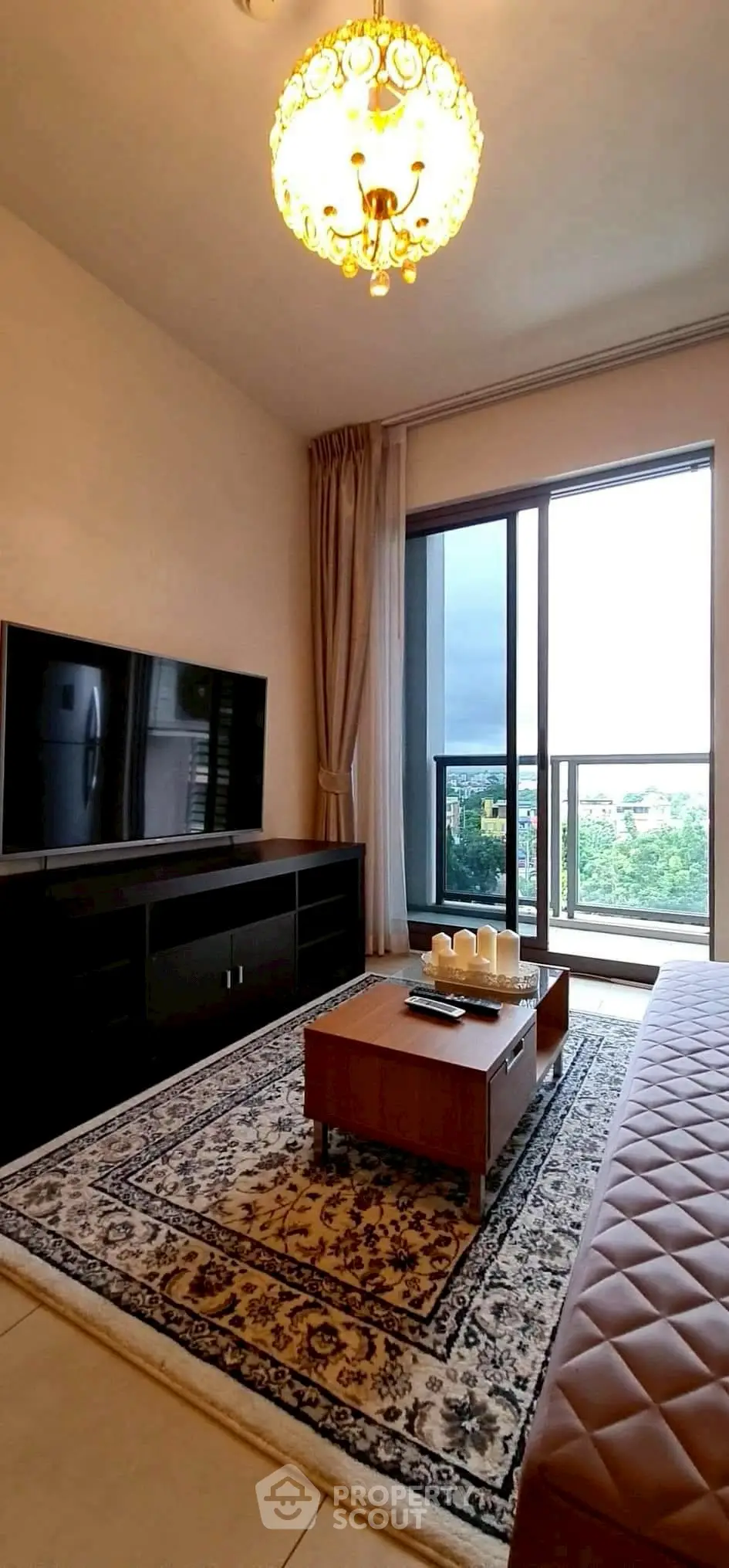 Elegant living room with large TV and stunning balcony view