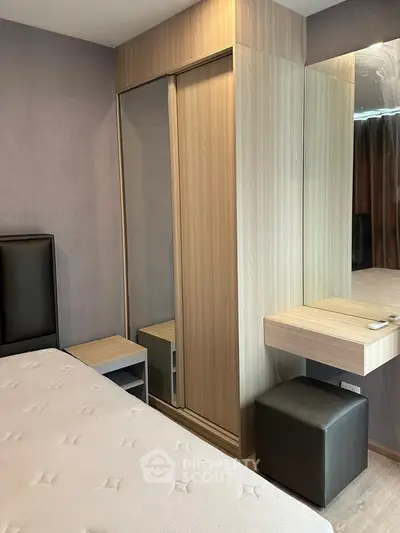 Modern bedroom with sleek wardrobe and stylish dressing table in a cozy apartment.