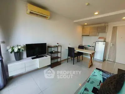 Modern living room with sleek furniture and open kitchen layout in a stylish apartment.