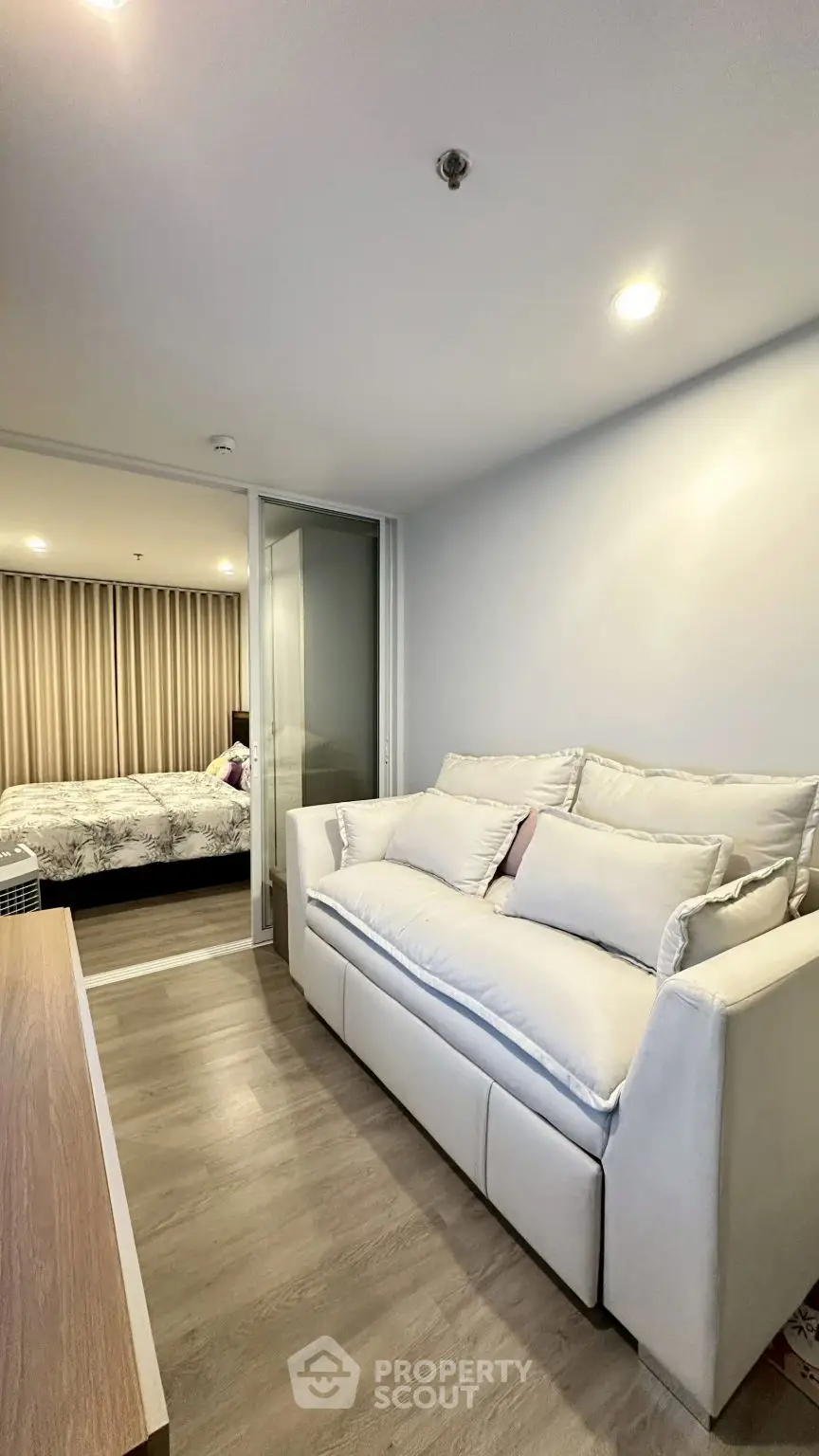 Modern apartment with cozy living area and stylish bedroom